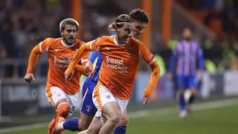 Josh Bowler sprints away from a Carlisle United opponent in the FA Cup tie between the sides in December