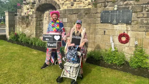 Royal fans Bartley Graham and Kerry Evans who are wearing fan attire with Union Jack flags and fancy dress accessories.