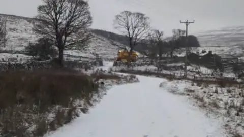 Supplied A snow-covered scene showing a gritter at the foot of a steep hill