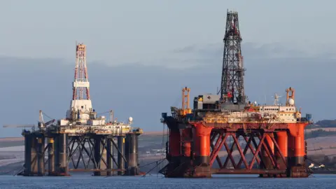 PA Media Two oil platforms in the Cromarty Firth.