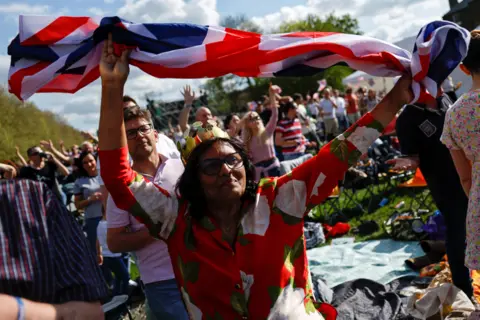 Reuters A person holds a Union Jack flag, along the Long Walk outside Windsor Castle, Britain, May 7