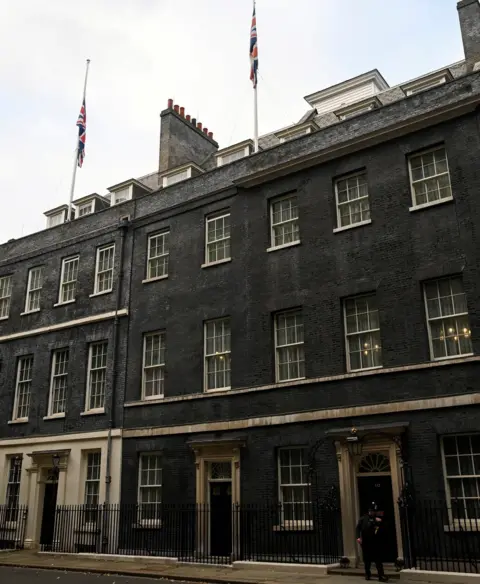 Reuters Flags are seen at half maston the roof of 10 Downing Street,