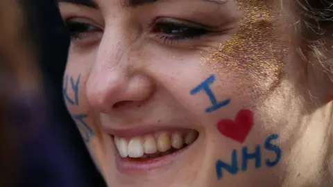 Getty Images Woman with I love NHS written on her face