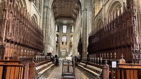 Shariqua Ahmed/BBC Altar at the Cathedral with choir stalls visible at either side