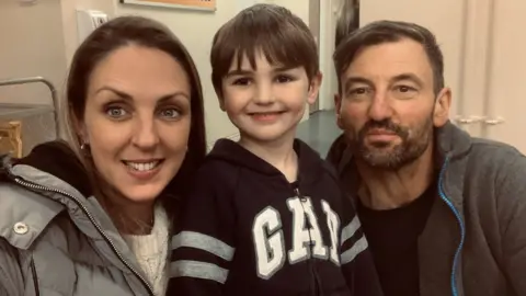 Family photograph Stephanie Peverell, pictured with her eldest son Alfie and husband Laurence,