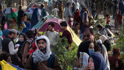 Getty Images Displaced Afghans arrive at a makeshift camp from the northern provinces desperately leaving their homes behind on August 10, 2021 in Kabul, Afghanistan.