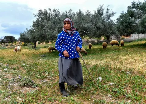 AFP A woman herds her sheep near the north-eastern Tunisian town of Korba on April 4, 2023