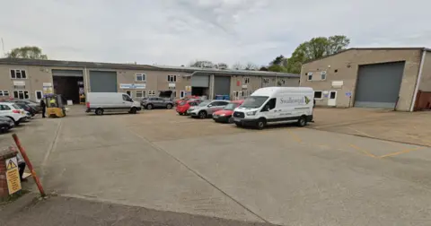 Google An industrial estate with a large forecourt. There is a small white van with the word Swallowtail on the site, and a picture of a yellow butterfly
