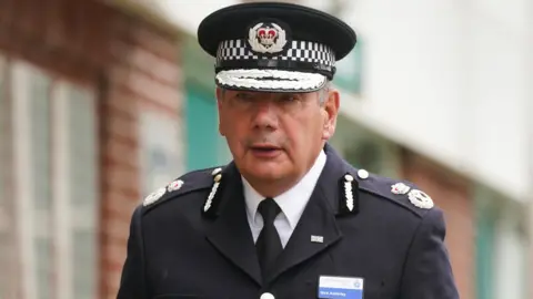 Police officer in uniform leaving a venue