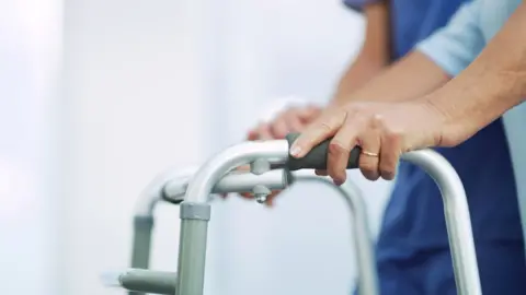 Getty Images Older person using walking frame