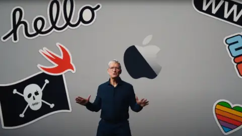 APple Tim Cook is seen against a backdrop