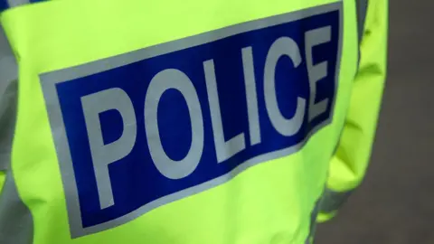 Hi vis jacket that says police