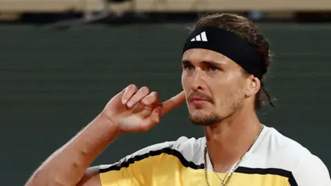 Alexander Zverev cups his ear at the French Open