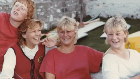 Suzy Lamplugh (second left) with her siblings, (left to right) Richard, Tamsin and Lizzie. All four have blonde hair, are smiling, and appear to be in their twenties.