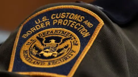 A close-up of a US Customs and Border Patrol patch seen on an agent's shoulder