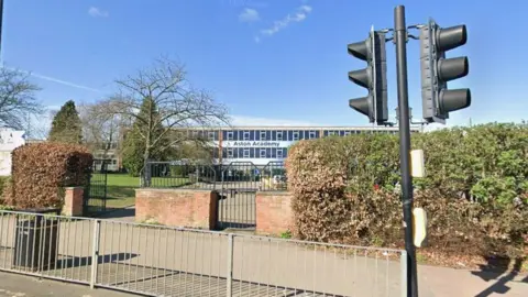Google Street View image of Aston Academy on Aughton Road in Swallownest, with the name of the school in large letters on a modern building.