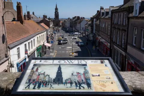 Richard Baker/Getty Images A Lowry picture on public display overlooking Castlegate in the town centre