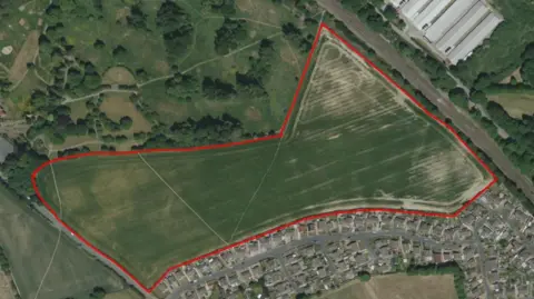 Wakefield Council  A map showing the red outline of the green farmland where the homes would be built, with existing houses to the south.