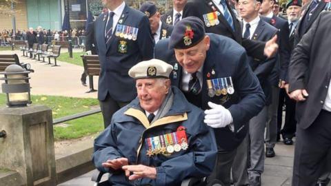 Ron Cunningham in a wheelchair at the cenotaph in Newcastle 