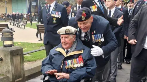 Ron Cunningham in a wheelchair at the cenotaph in Newcastle 