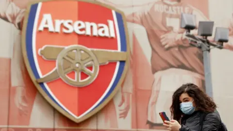 Reuters Woman in mask outside emirates