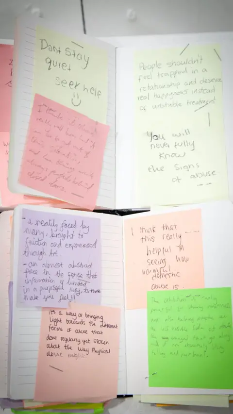 Gemma Briggs A series of handwritten notes stuck in the pages of two small lined notebooks. For example, one says "Dont stay quite seek help" and another says "I think that this really helpful in seeing how normal domestic abuse is".