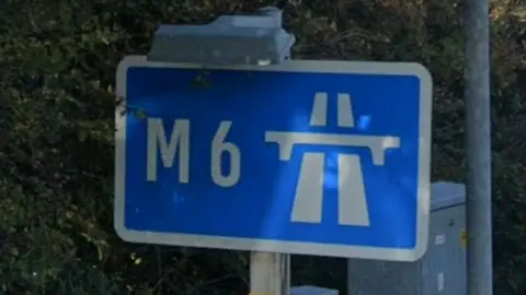 Google Blue and white sign with M6 written on it, alongside a symbol for a motorway
