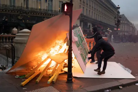 Lafargue Raphael/ABACA/REX/Shutterstock Burning barricades on the place de l opera during a demonstration in Paris on March 23, 2023.