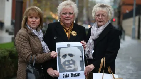 Pacemaker John McKerr's three daughters Agnes, Anne and Mo holding a photograph of their father