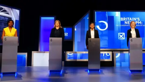 PA Media Kemi Badenoch, Penny Mordaunt, Rishi Sunak, and Liz Truss on stage during the Channel 4 Tory leadership debate