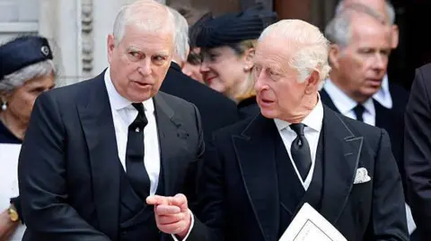 Max Mumby/Indigo/Getty Images Andrew and King Charles are dressed in dark funeral attire, attending the funeral of the Duchess of Kent earlier this year. 