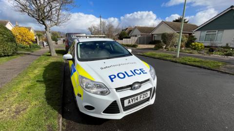 A police car near the scene at Grayson Avenue, Pakefield, Suffolk