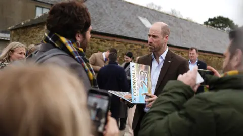PA Media The Prince of Wales, known as the Duke of Cornwall while in Cornwall, meeting well-wishers during his visit to the Gear Farm Pasty Company, 