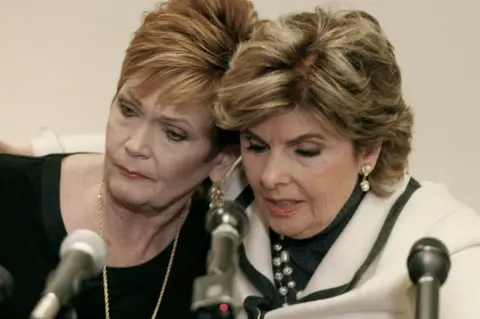 Reuters Ms Nelson (left) with her lawyer at a press conference on Friday