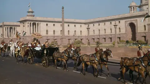 Getty Images Queen Elizabeth II and the Duke of Edinburgh, accompanied by President Rajendra Prasad, leave the Rashtrapati Bhavan presidential palace in an open carriage to attend the Republic Day Parade, New Delhi, January 26th 1961. (Photo by Fox Photos/Hulton Archive/Getty Images)