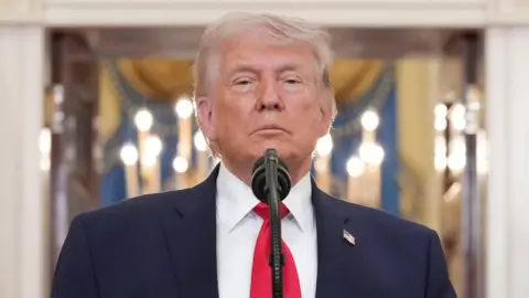 US President Donald Trump speaks from a podium.
