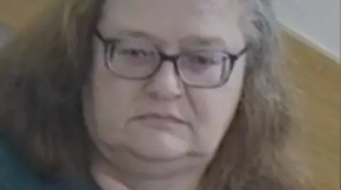 Sally Burborough looking at the camera. She is not smiling.