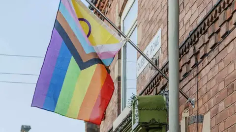 A multi-coloured pride flag