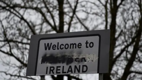 Reuters A defaced "Welcome to Northern Ireland" sign stands on the border in Middletown, Northern Ireland