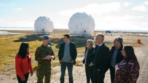 Reuters Jens Stoltenberg (third from right) with Canadian Prime Minister Justin Trudeau in Cambridge Bay, Nunavut, on Thursday