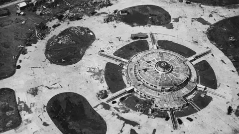 Getty An aerial image of a circular building with tunnels coming out of the side of it.