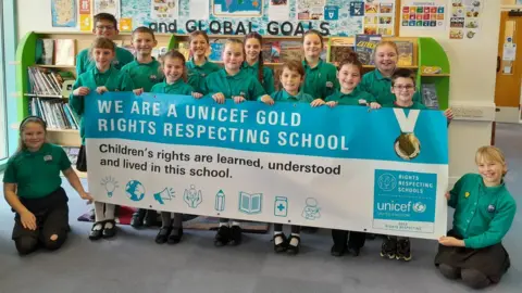 States of Guernsey Hautes Capelles Primary School pupils holding a banner