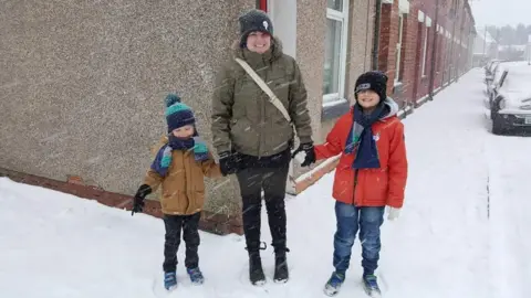 Kat Williams Kat with her sons in the snow