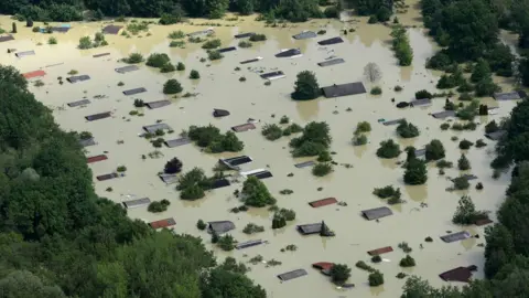 AFP This file photo taken on 6 June 2013 shows an aerial view of summer houses flooded by water from the River Danube near the Bavarian village Deggendorf, southern Germany