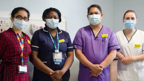 Tim Pellatt Four hospital workers in uniform