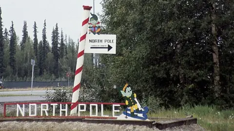 Independent Picture Service via Getty Images A road sign for the North Pole Chamber of Commerce, Alaska.
