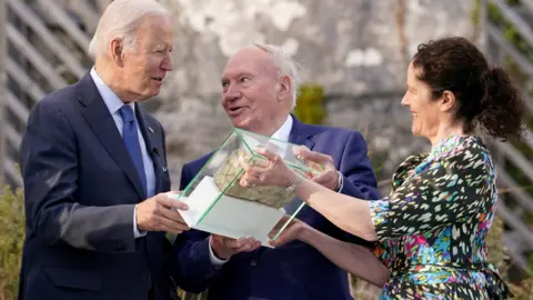Reuters President Biden presented with brick from ancestral home in Ballina
