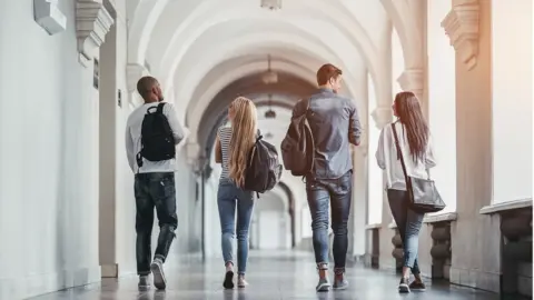 Getty Images students walk along corridor