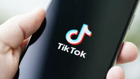 NurPhoto TikTok logo on phone
