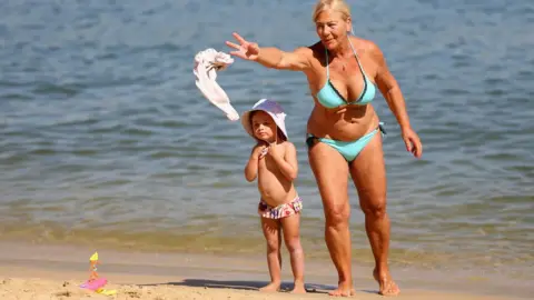 Getty Images Grandmother and granddaughter take a dip in the water at Red Leaf Beach on January 15, 2019 in Sydney, Australia